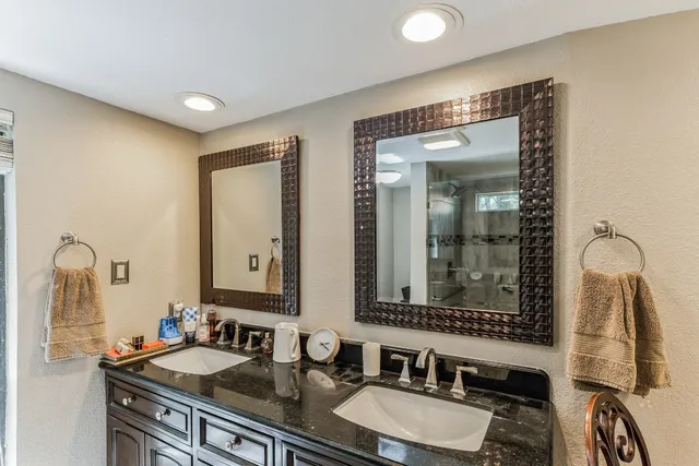 a bathroom with 2 sink and a mirror