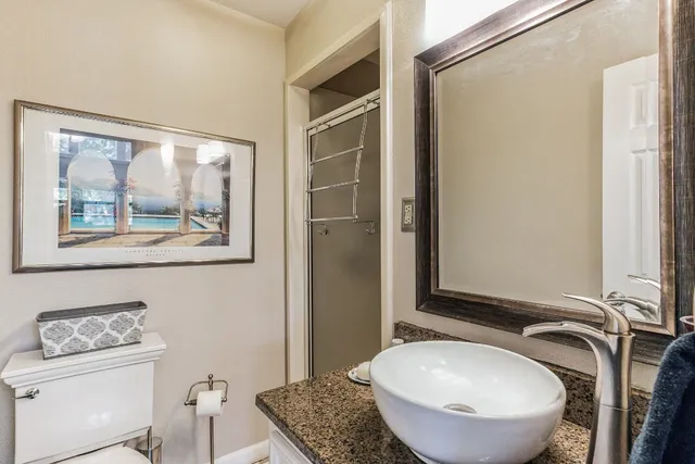 a bathroom with a toilet a sink and mirror
