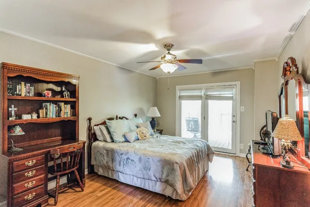 a bedroom with a bed bookshelf and a window