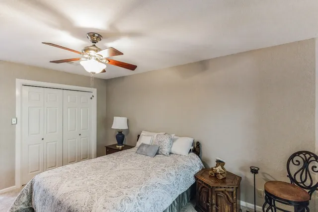 a bedroom with a bed and chandelier