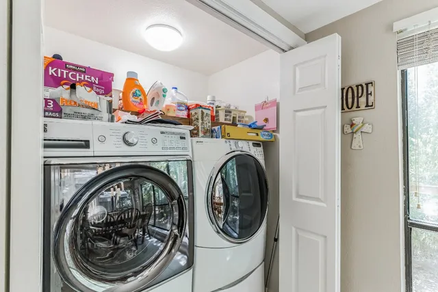 a view of pool with lawn chairs and plants