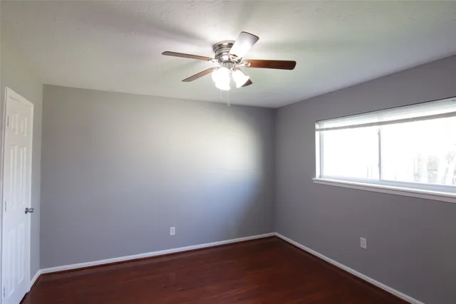 a bathroom with a granite countertop toilet a sink and a mirror