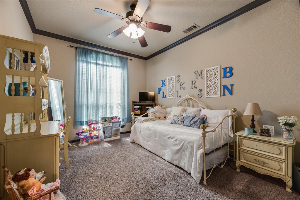 1132 Chartres Street Kaufman, TX 75142 - Photo 15 of 25 Spacious room featuring textured walls with crown molding, a ceiling fan with integrated lighting, and a large window with vertical blinds