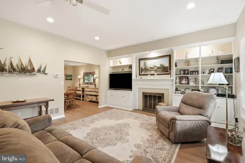 a living room with furniture flat screen tv and a fireplace