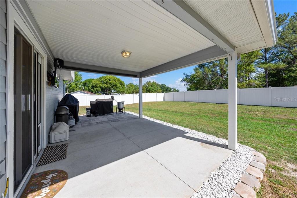 13 Teak Loop Place Ocala, FL 34472 - Photo 13 of 36 a view of a patio with a table and chairs under an umbrella