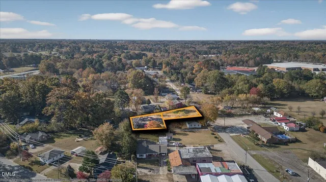 an aerial view of a house with a yard and lake view