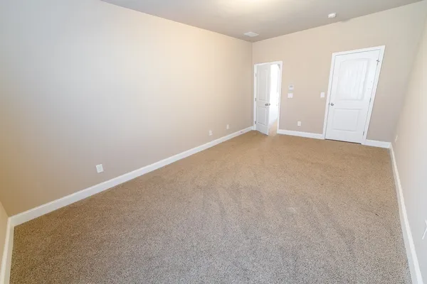 a living room with stainless steel appliances furniture a rug and a window