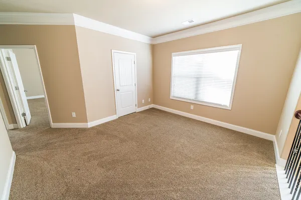 an empty room with windows and closet