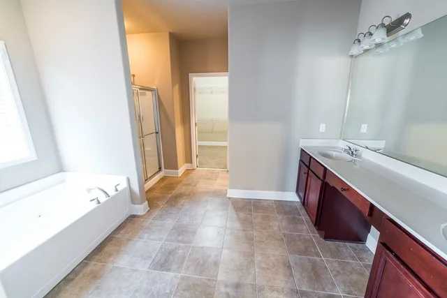 a bathroom with a granite countertop shower and a toilet