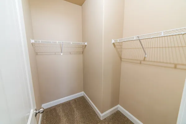 a view of a hallway with wooden floor and entryway