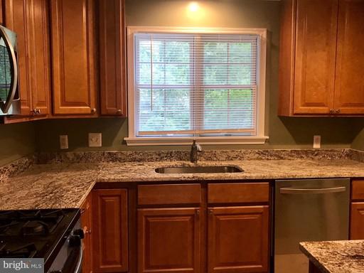 8905 Flower Avenue Silver Spring, MD 20901 - Photo 12 of 17 a kitchen with granite countertop cabinets sink and window
