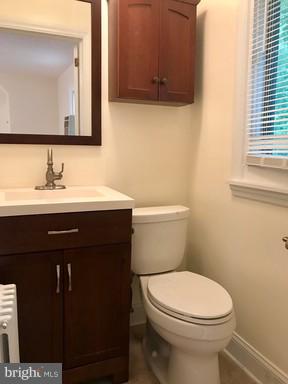 8905 Flower Avenue Silver Spring, MD 20901 - Photo 4 of 17 a bathroom with a sink a toilet and mirror