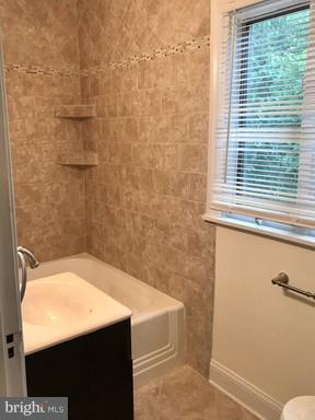 8905 Flower Avenue Silver Spring, MD 20901 - Photo 5 of 17 a bathroom with a sink a toilet and a shower