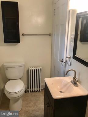 8905 Flower Avenue Silver Spring, MD 20901 - Photo 6 of 17 a bathroom with a toilet a sink and a mirror