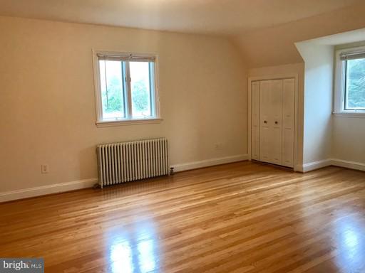 8905 Flower Avenue Silver Spring, MD 20901 - Photo 8 of 17 a view of an empty room with wooden floor and a window