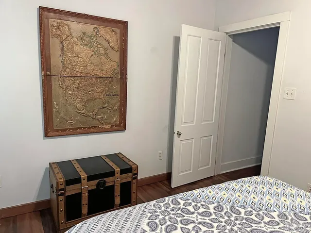 a bedroom with a bed and a window