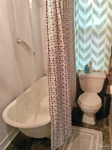 a bedroom with a bed and a large mirror