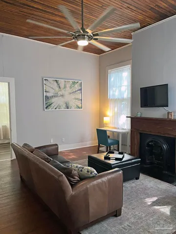 a living room with furniture and a fireplace