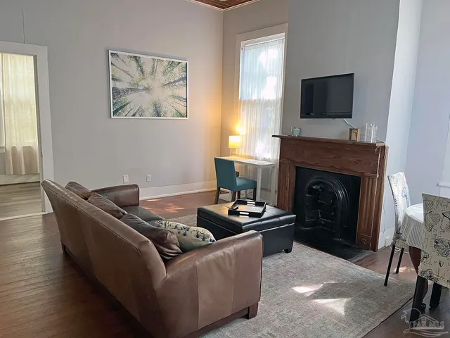 a living room with furniture and a air conditioner