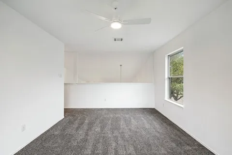 an empty room with windows and closet