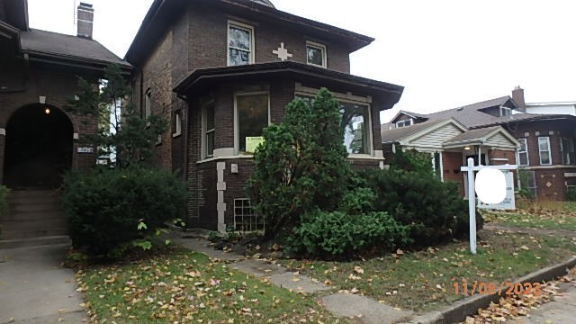 8217 South Rhodes Avenue Chicago, IL 60619 - Photo 1 of 22 a front view of a house with plants