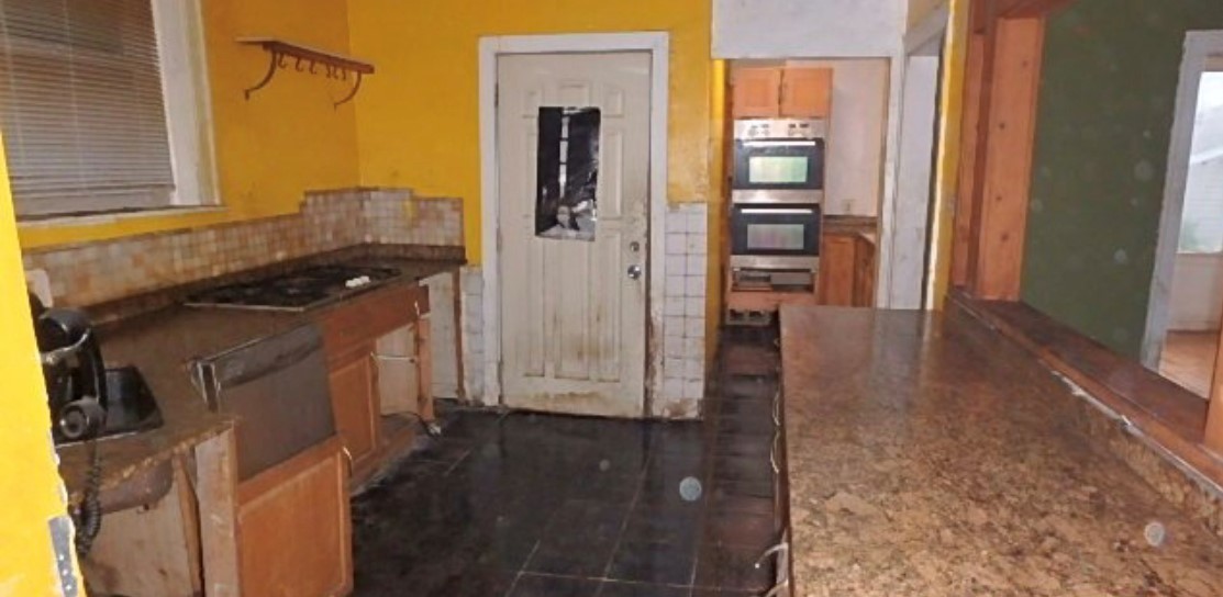 8217 South Rhodes Avenue Chicago, IL 60619 - Photo 13 of 22 a kitchen with a refrigerator and a stove top oven