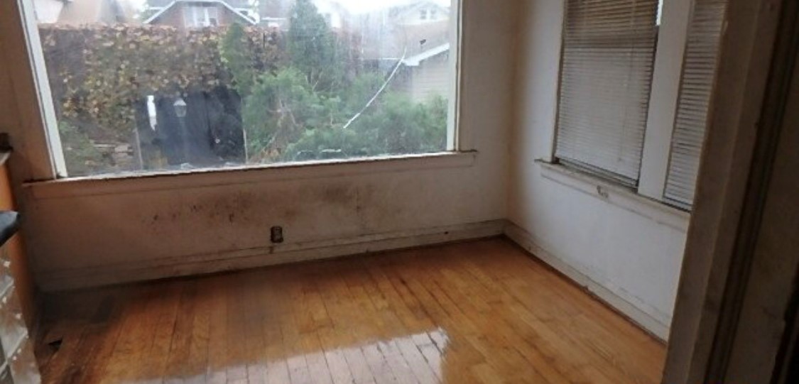 8217 South Rhodes Avenue Chicago, IL 60619 - Photo 16 of 22 a view of a small space with wooden floor and a window