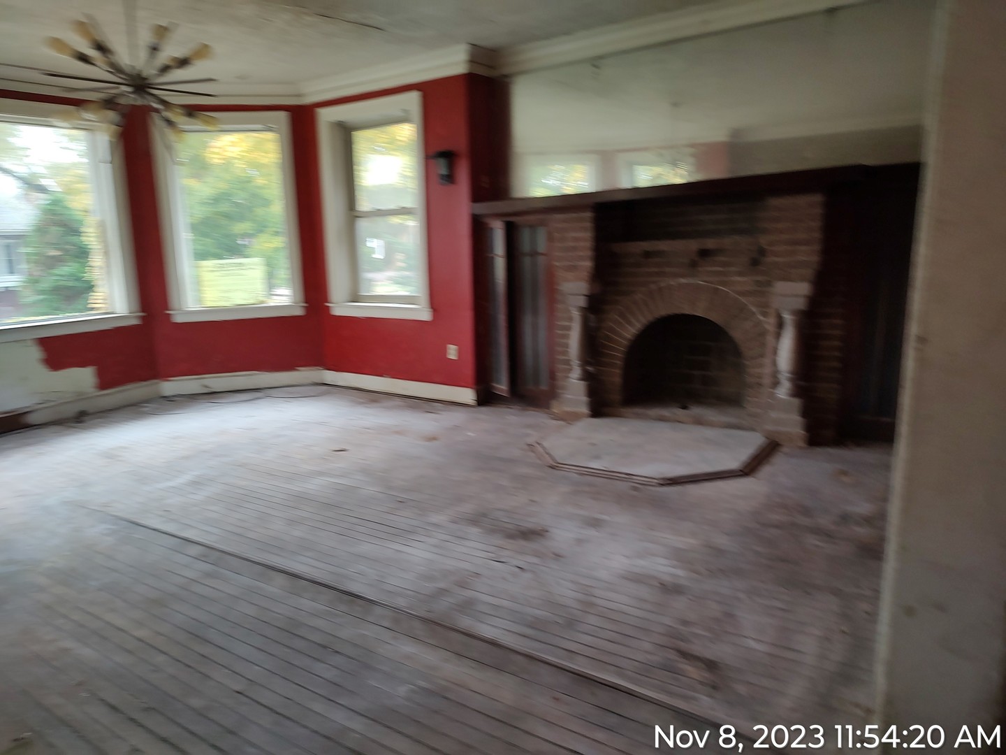 8217 South Rhodes Avenue Chicago, IL 60619 - Photo 3 of 22 a view of an empty room with a fireplace and a window
