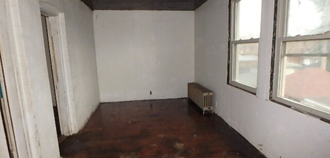 8217 South Rhodes Avenue Chicago, IL 60619 - Photo 5 of 22 a view of a hallway with wooden floor and stairs