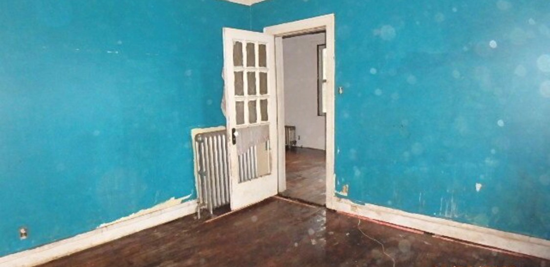 8217 South Rhodes Avenue Chicago, IL 60619 - Photo 7 of 22 an empty room with a door