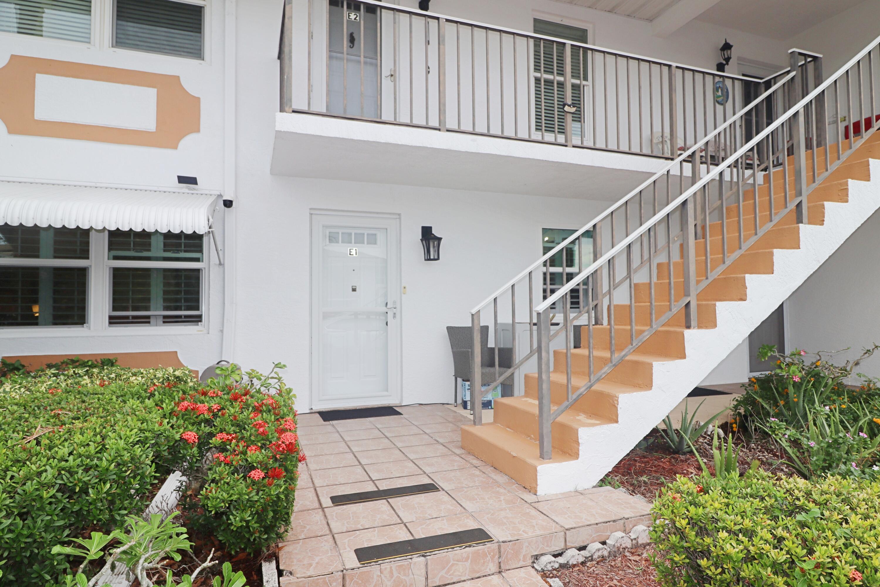 a view of staircase with white walls and a potted plant