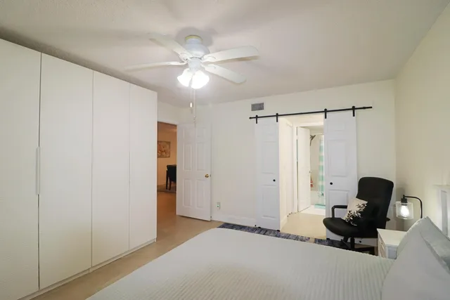 a view of a livingroom with workspace and a window