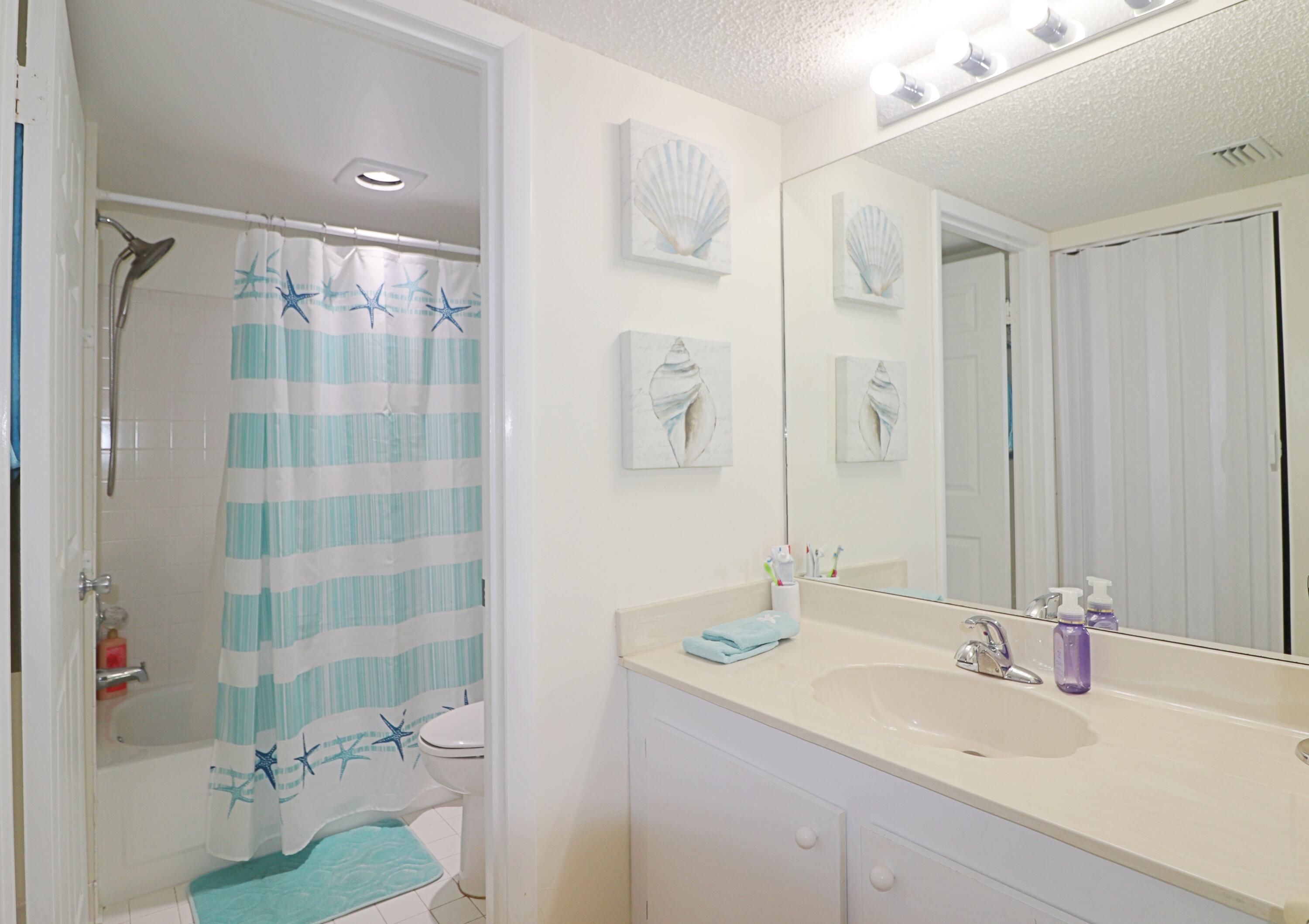 133 Lakes End Drive, Unit E1 Fort Pierce, FL 34982 - Photo 19 of 29 a bathroom with a sink double vanity and shower