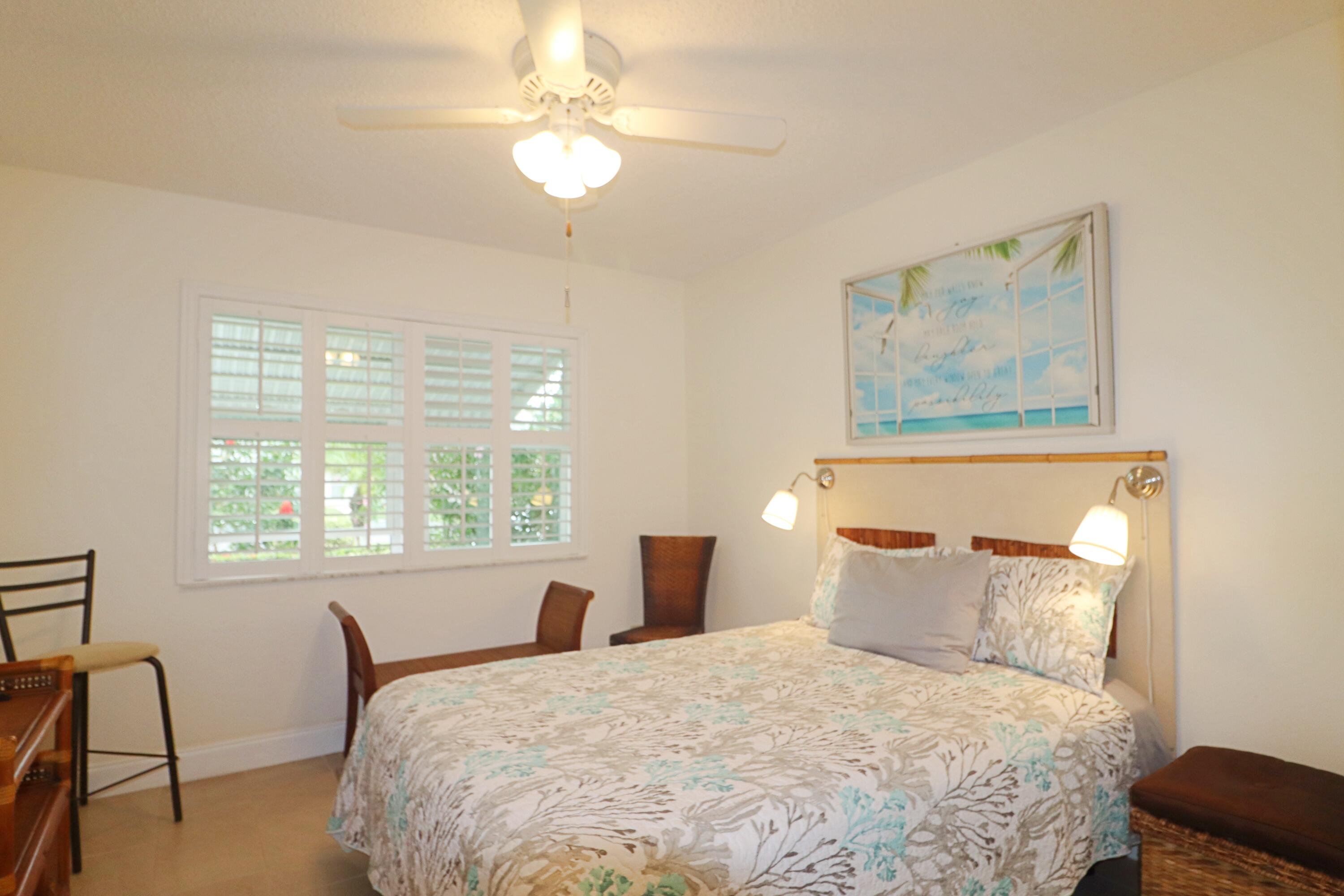 133 Lakes End Drive, Unit E1 Fort Pierce, FL 34982 - Photo 21 of 29 a bedroom with a bed and a window