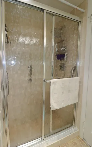 a bathroom with a glass shower door
