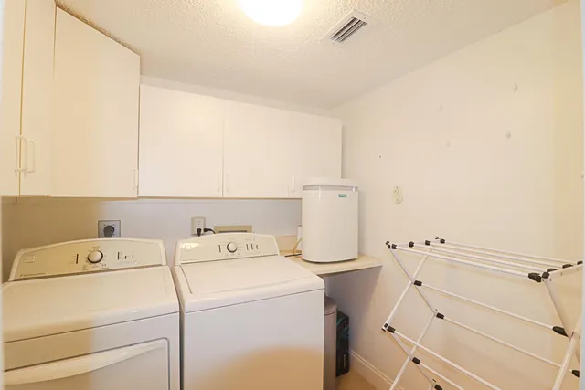 a view of storage and utility room with washer and dryer