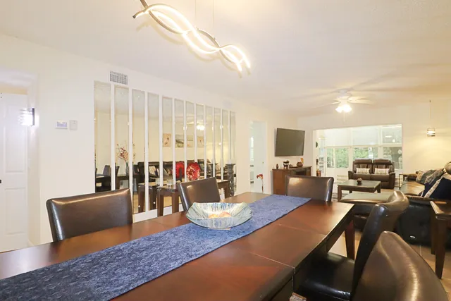 a living room with furniture dining table and a flat screen tv