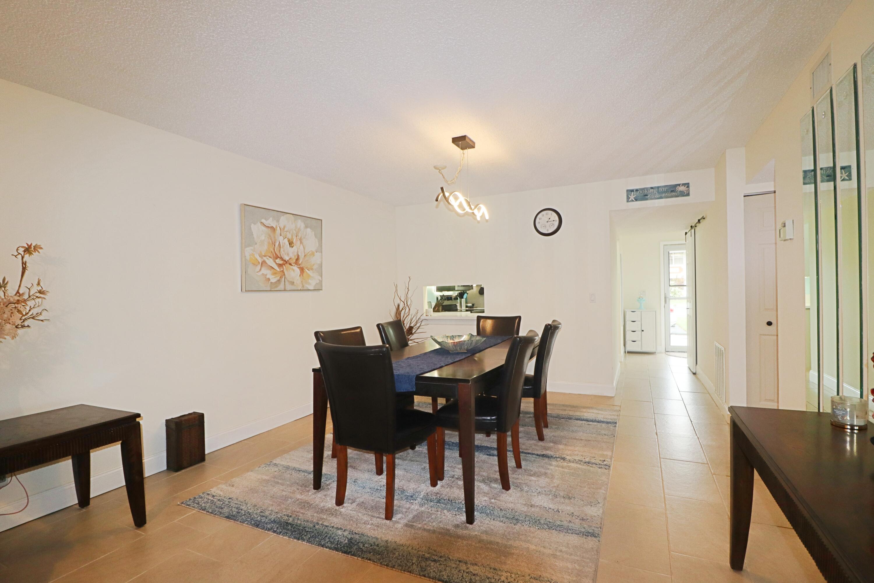 133 Lakes End Drive, Unit E1 Fort Pierce, FL 34982 - Photo 9 of 29 a view of a dining room with furniture