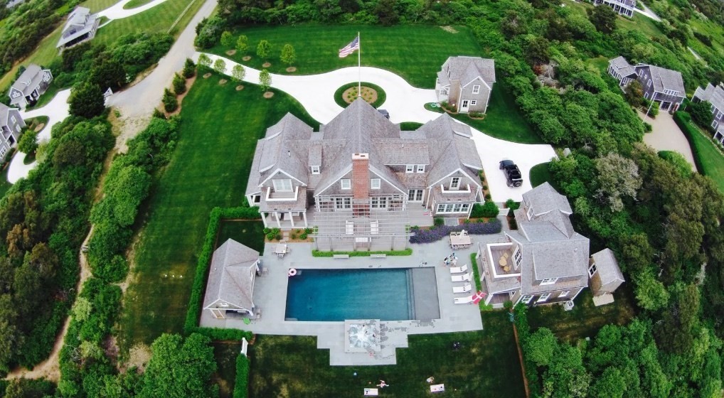 an aerial view of a house with outdoor space and sitting area