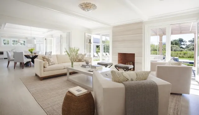 a living room with furniture wooden floor and a large window