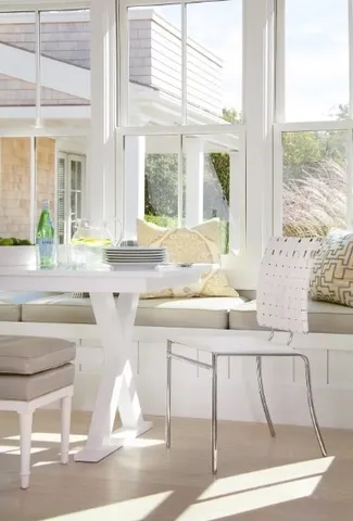 a kitchen with granite countertop white cabinets and a large window