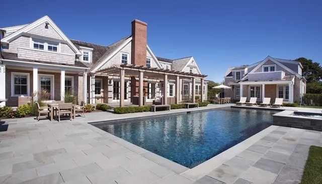 a view of a building with swimming pool and sitting area