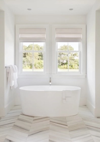 21 Woodbine Street Nantucket, MA 02554 - Photo 8 of 19 a white bath tub sitting in a bathroom next to a window