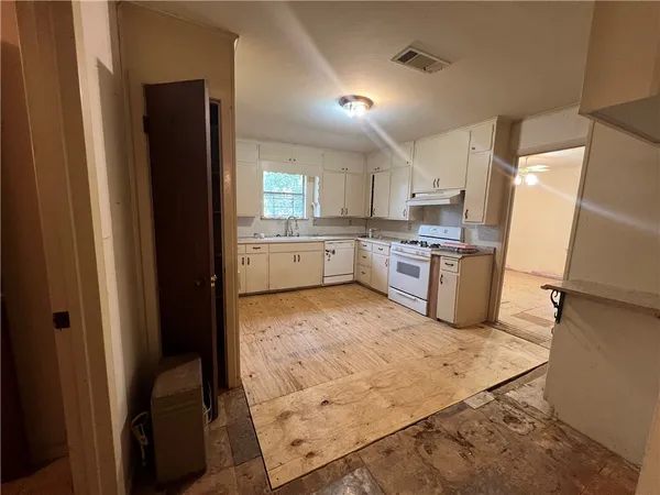 a kitchen with wooden cabinets and refrigerator