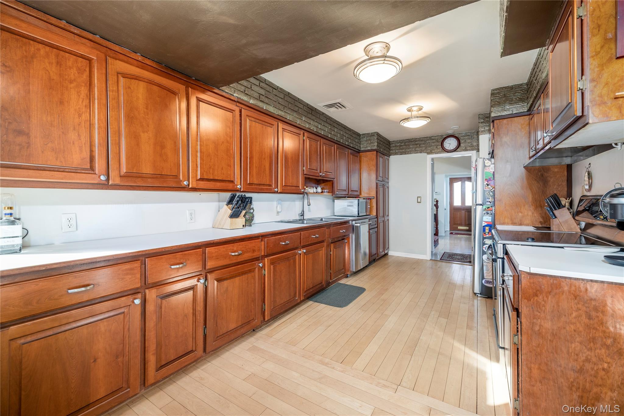 136 Greenway Road Lido Beach, NY 11561 - Photo 11 of 29 a kitchen with stainless steel appliances granite countertop a sink a stove and a refrigerator