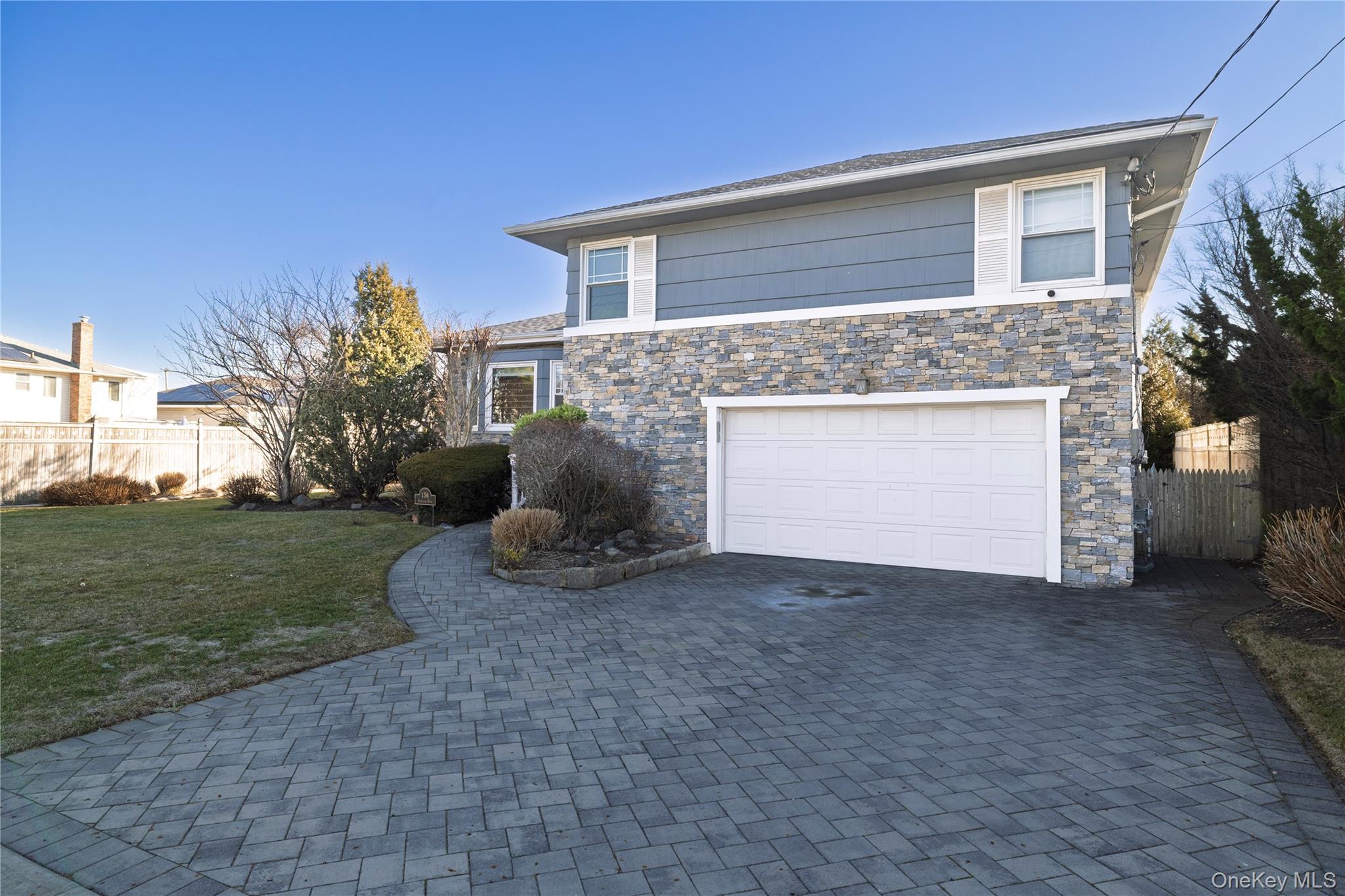136 Greenway Road Lido Beach, NY 11561 - Photo 2 of 29 a view of a house with a yard and a garage