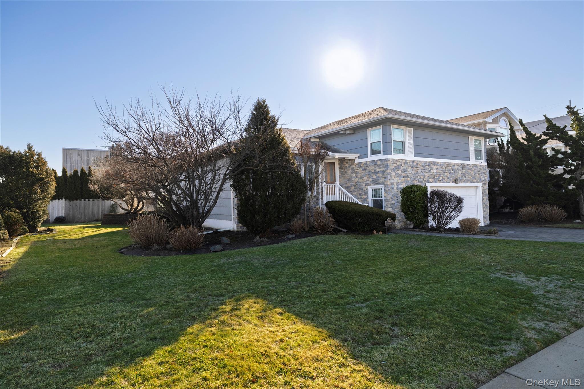 136 Greenway Road Lido Beach, NY 11561 - Photo 3 of 29 a front view of a house with garden