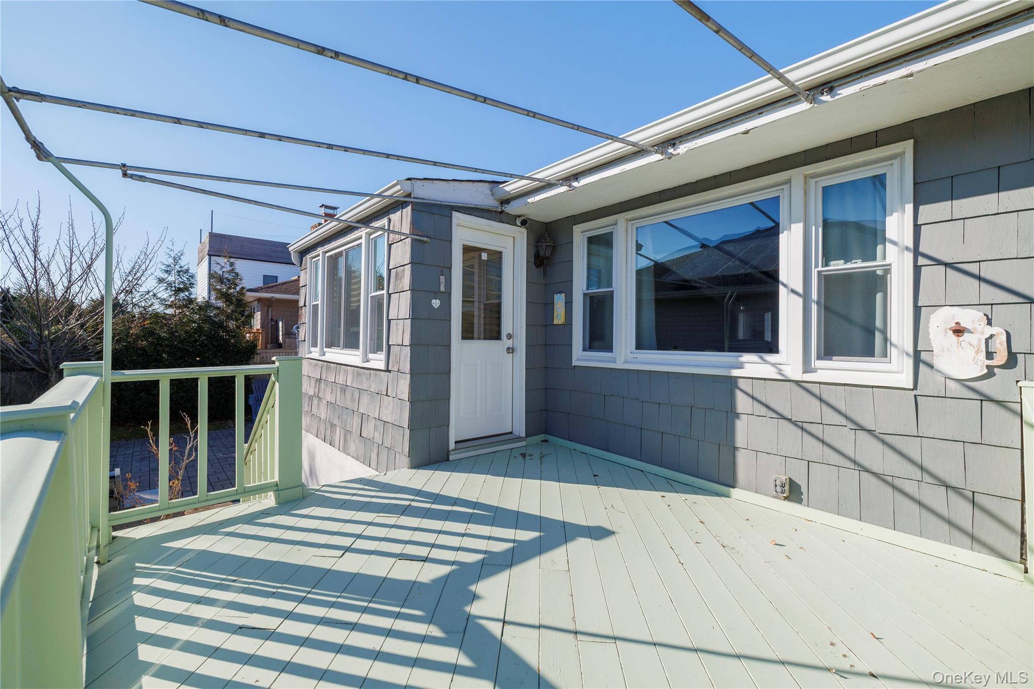 136 Greenway Road Lido Beach, NY 11561 - Photo 9 of 29 a front view of a house with a garden