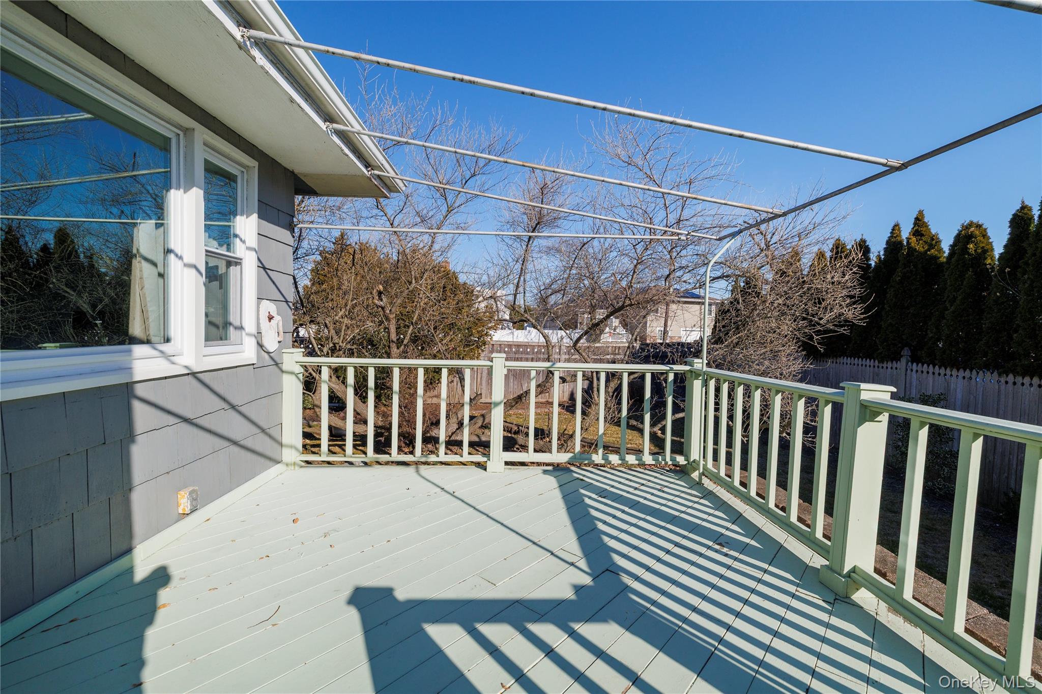 136 Greenway Road Lido Beach, NY 11561 - Photo 10 of 29 a view of balcony with wooden floor and fence