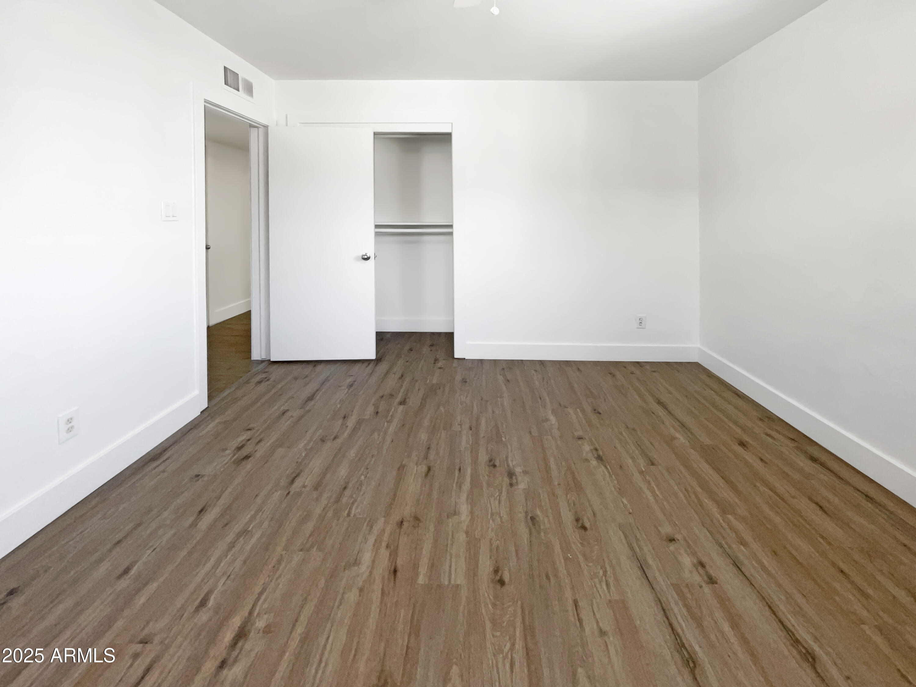 7231 North 23rd Avenue Phoenix, AZ 85021 - Photo 4 of 28 a view of an empty room with wooden floor